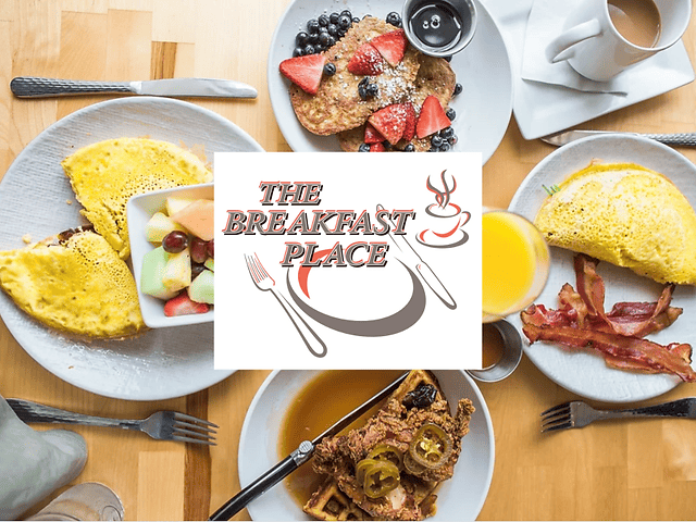 A top-down view of a table with breakfast dishes, including omelettes, pancakes with berries, a bowl of fruit, bacon, orange juice, and a coffee cup. The center features the logo